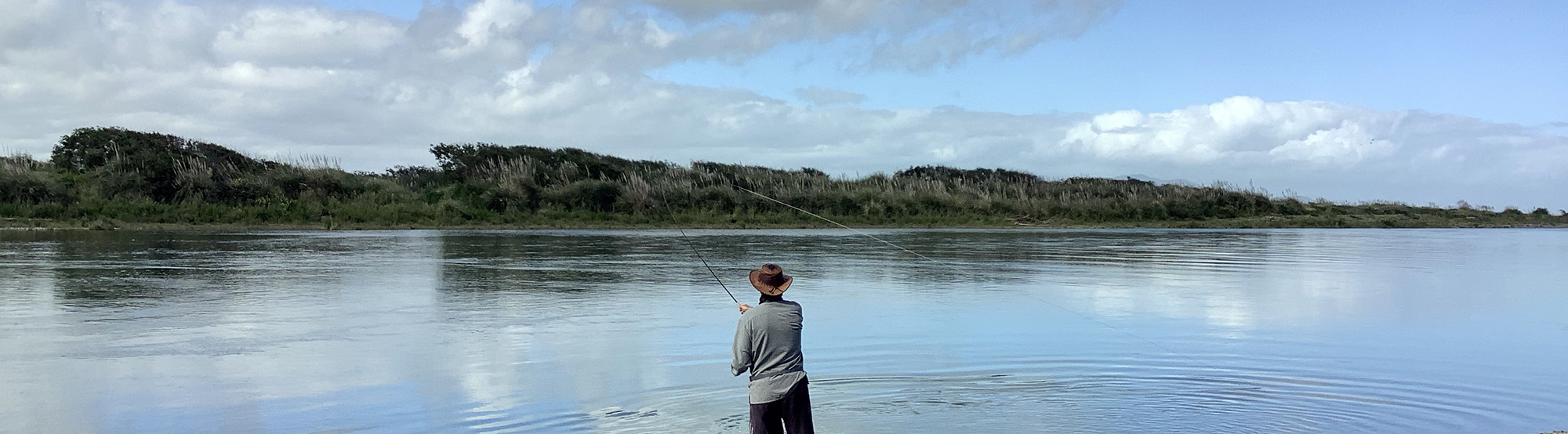 man-wearing-hat-double-spey-casting-on-river
